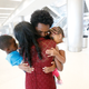 Olympic silver medalist Feyisa Lilesa, rear, of Ethiopia, hugs his wife Iftu Mulia, his daughter Soko, right, 5, and son Sora, left, 3, while picking up his family at Miami International Airport, Tuesday, Feb. 14, 2017, in Miami. Lilesa arrived in the U.S. on a special skills visa, which allows him to train and compete until January. His wife, son, daughter and brother joined him in Miami Tuesday.